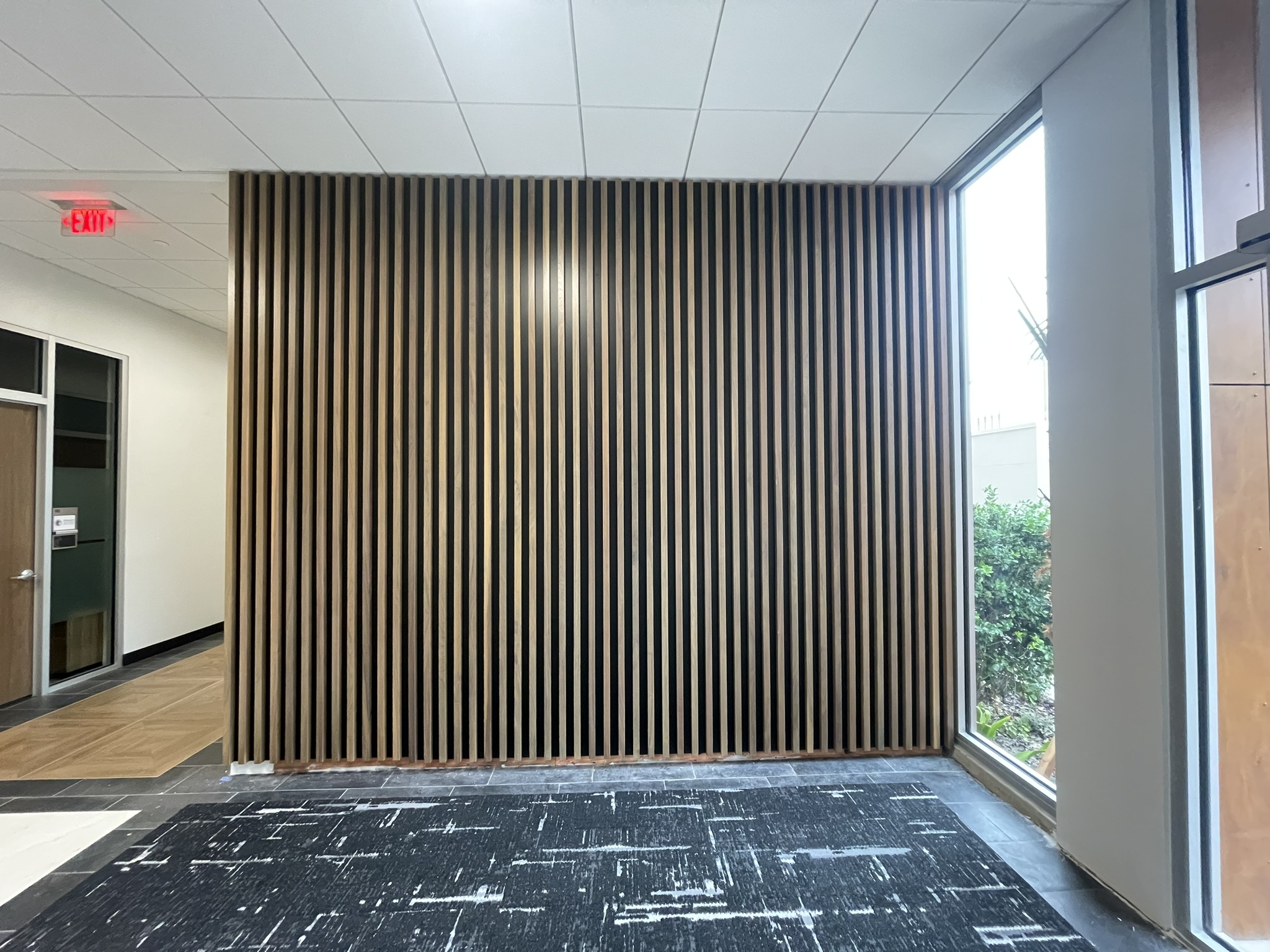 Architectural wood slat wall installation in a commercial corridor by St. Cloud Pro-Services LLC