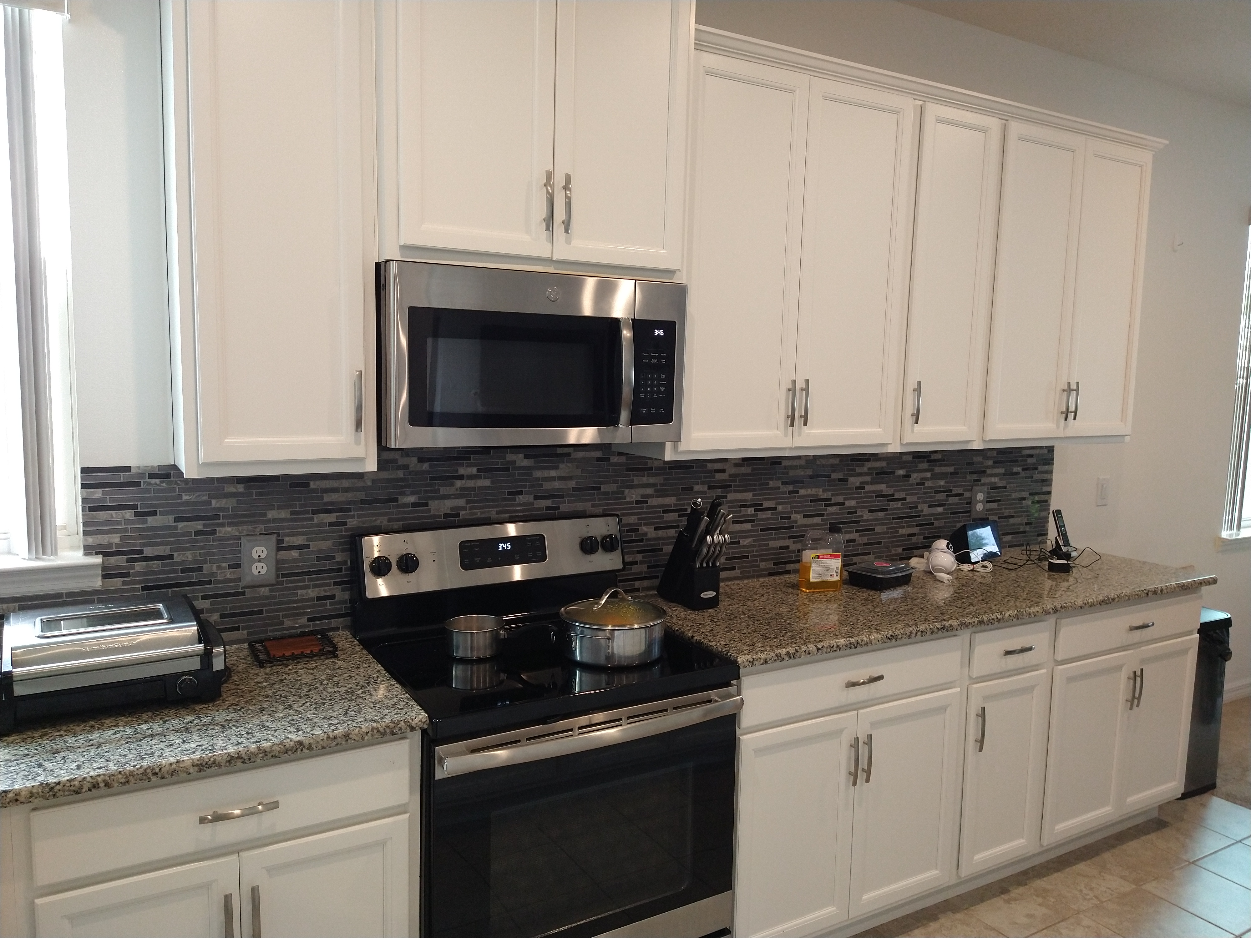 Residential kitchen cabinetry installation with granite countertops by St. Cloud Pro-Services LLC